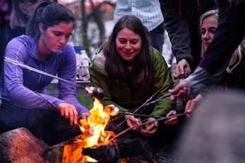 students around a campfire