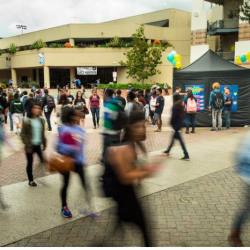 A proxe station set up in the midst of a busy campus plaza