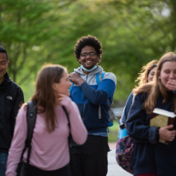 Group of students walking and smiling