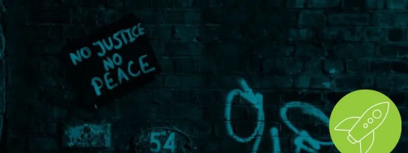 Dark cyan brick wall with a sign propped up reading "No Justice No Peace"  