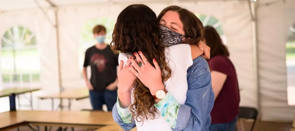 Returning to campus, hugging in reunion