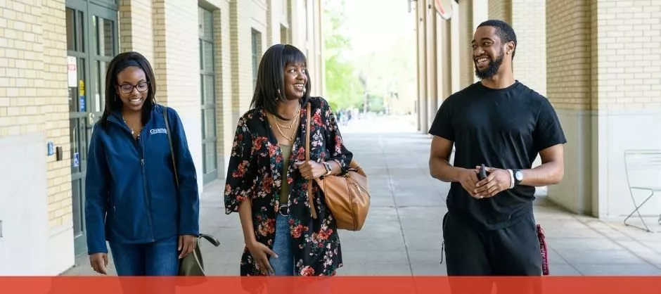 Three people walking and chatting