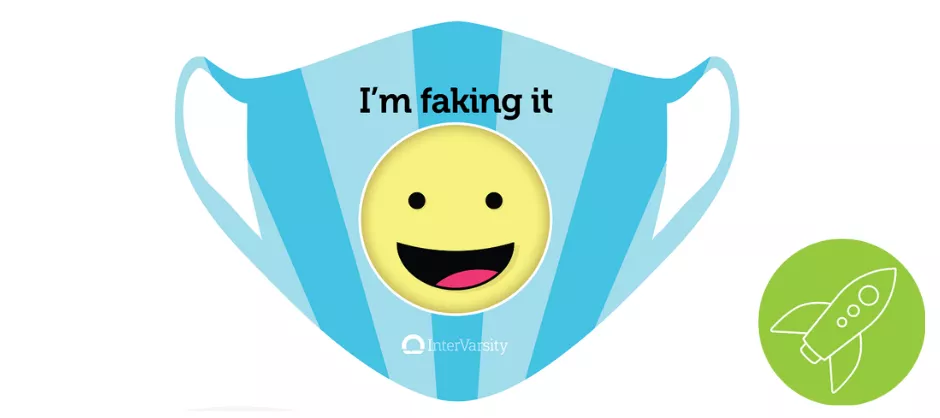 blue face mask with a smiling emoji and text I'm faking it