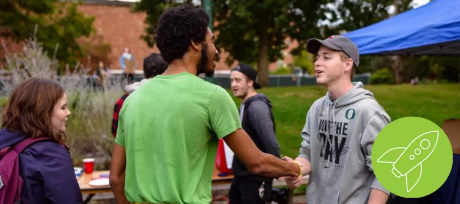 students shaking hands in greeting