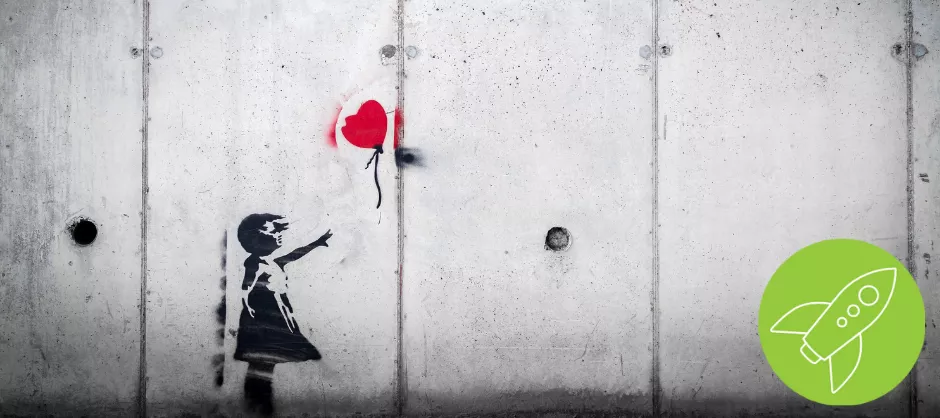 wall painting of a red heart balloon floating away from a girl