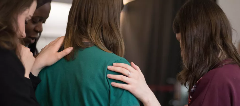 woman receiving prayer from other women