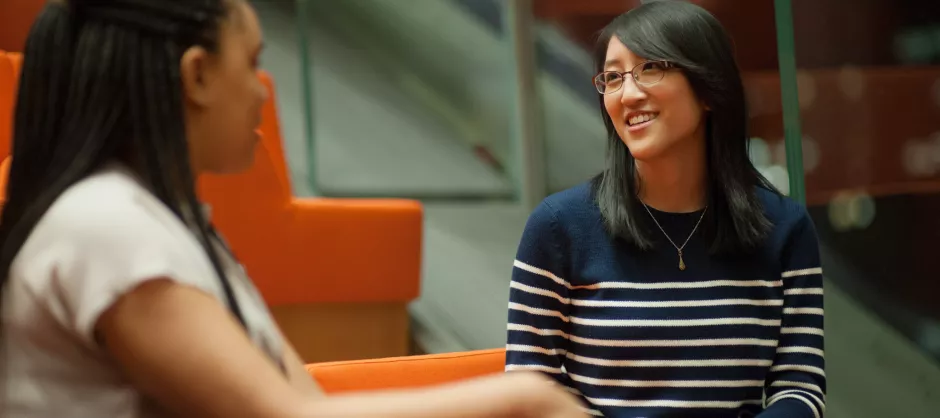 Woman talking to another and smiling