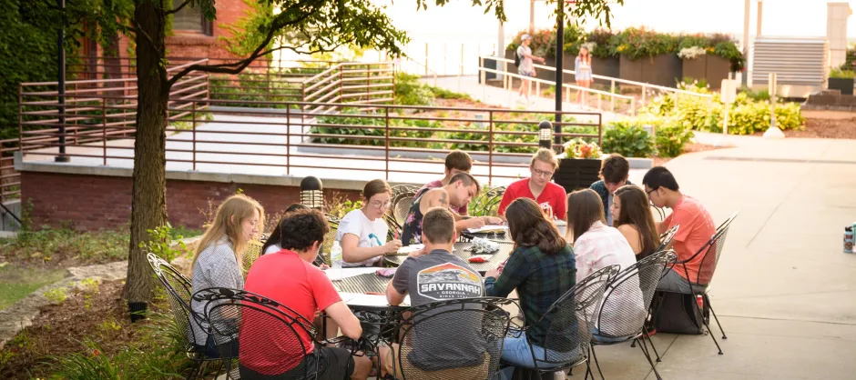 students sitting around a table outdoors