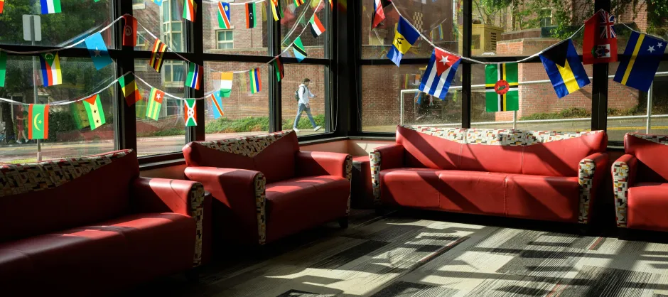 flags of countries hanging over empty couches
