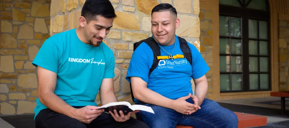 two men looking at a book together