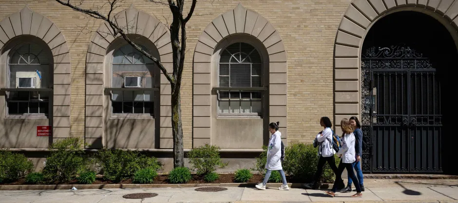 students walking on a sidewalk