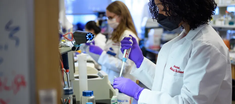 The side profile of a medical student working in a lab.