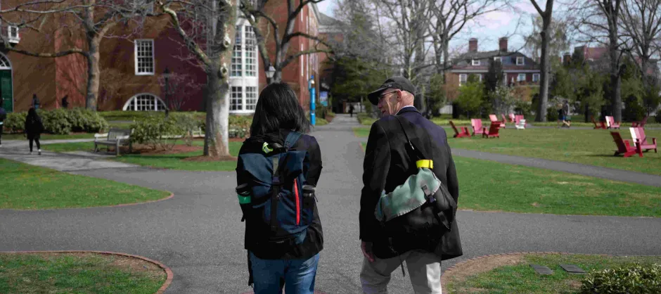 two faculty walking on campus