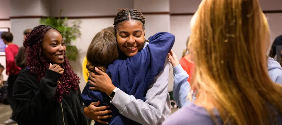 Students hugging and smiling