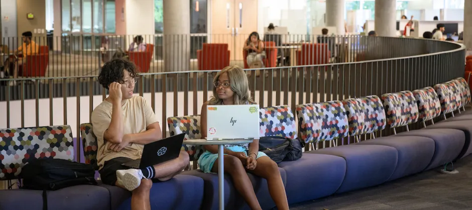 two students in a campus building