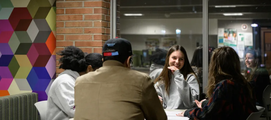 people gathered around a table talking