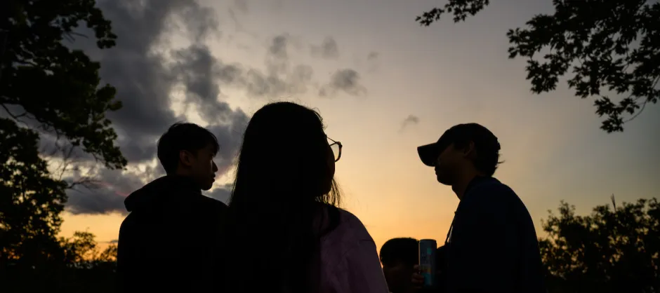 Three people at night
