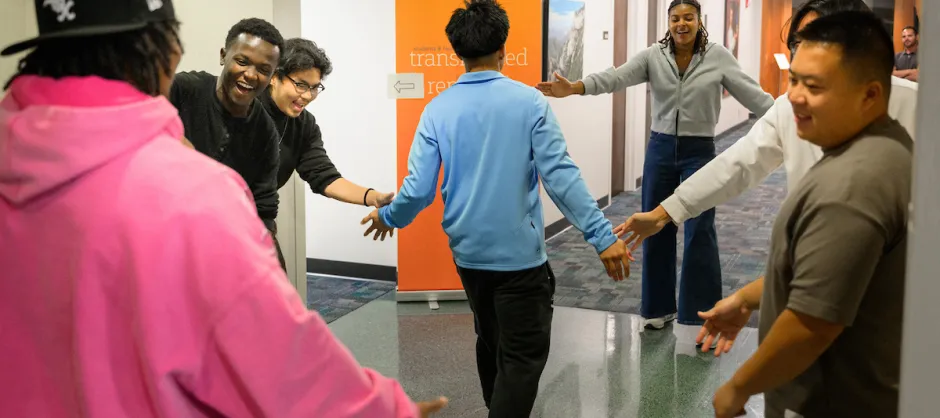 People being greeted in a hallway