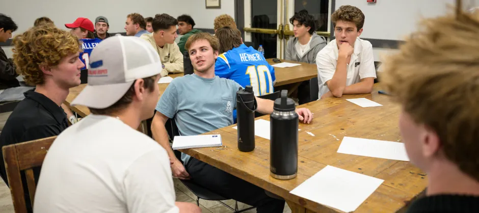 Guys sitting around a table