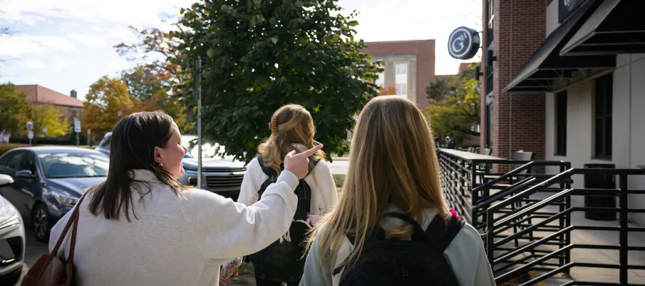 Three girls walking away from the camera