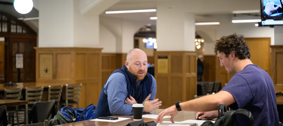 Two men talking across the table from each other