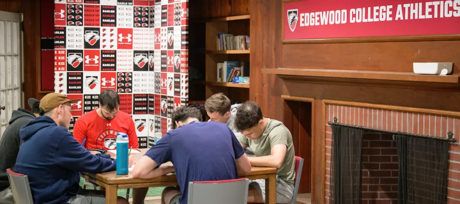 Guys praying together around a table