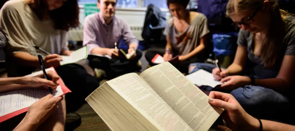 a group of people in bible study