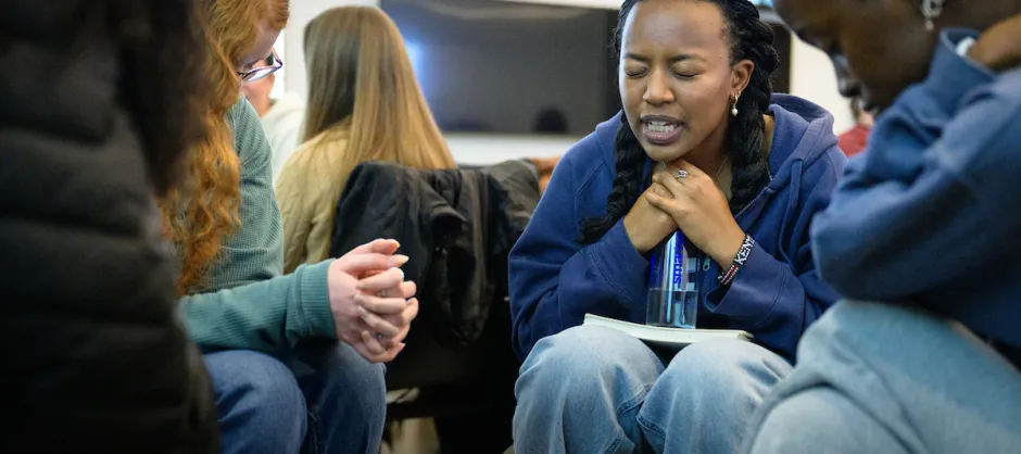 A group of college students praying