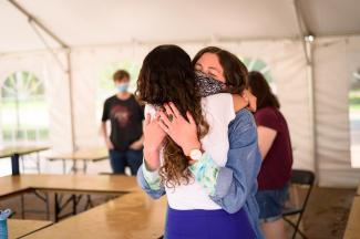 Returning to campus, hugging in reunion