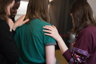 woman receiving prayer from other women