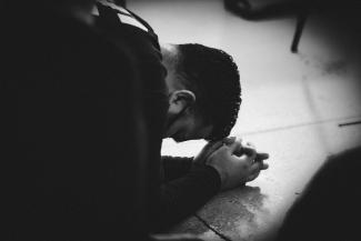 Engaging in Confession Prayer banner (person on the ground praying)